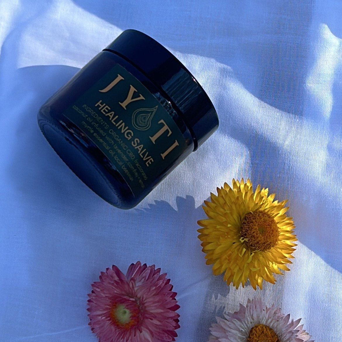 CBD Healing Salve handcrafted with organic regeneratively grown botanicals in amber glass jar by JYOTI