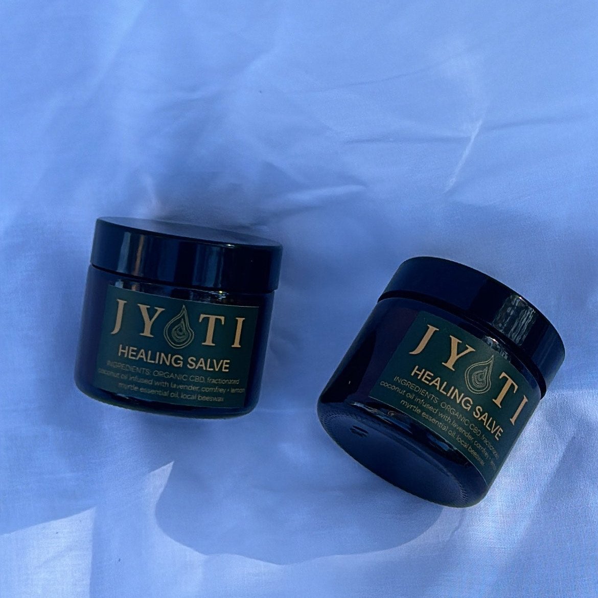 JYOTI CBD Healing Salve sitting on white linen to show Australian made packaging and labels 